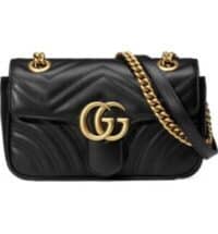 Black Gucci Mini Bag with gold strap.