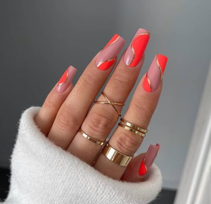 neon orange nails with design